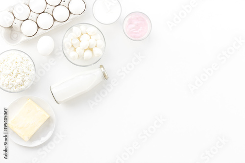 Natural farm products. Milk, cottage, eggs, cheese, yougurt on white background top view copy space. Monochrome