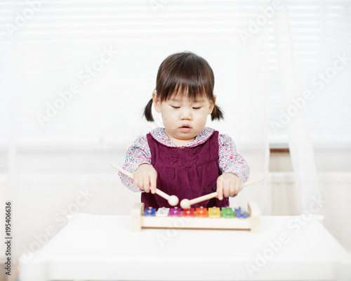 baby girl play xylophone at home