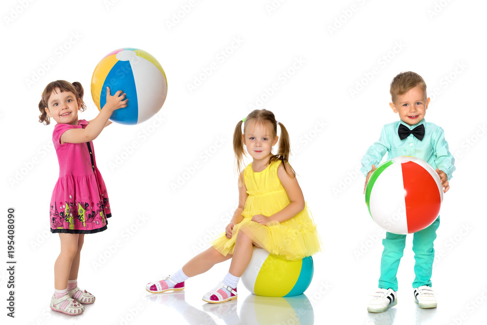 Cheerful children play with a ball.