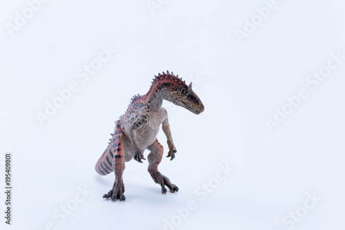 Cryolophosaurus dinosaur in attack position with white background mouth close