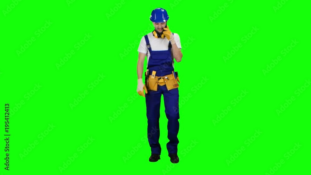 Builder speaks on the phone and screams at his subordinates. Green screen Builder speaks on the phone and screams at his subordinates. Green screen