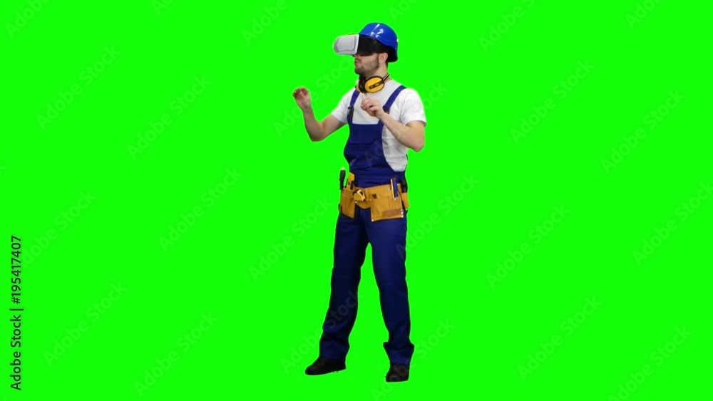 Engineer with virtual reality glasses looks at the building. Green screen Engineer with virtual reality glasses looks at the building. Green screen