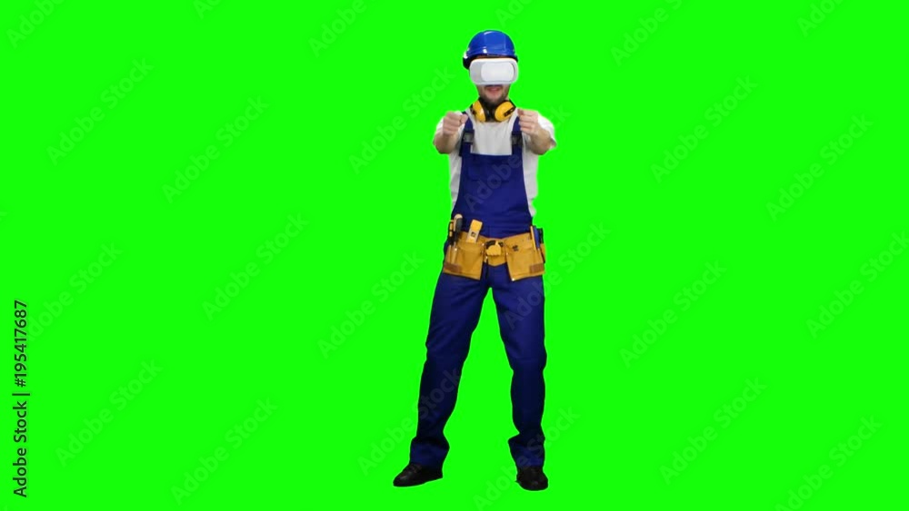 Engineer with virtual reality glasses builds an object. Green screen Engineer with virtual reality glasses builds an object. Green screen