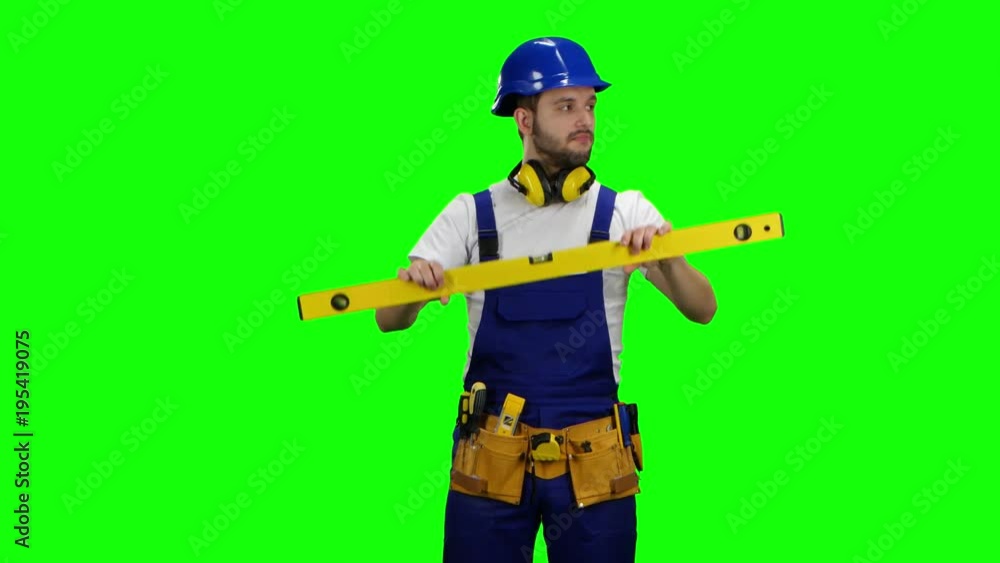 Brigadier measures the angles with the construction level. Green screen Brigadier measures the angles with the construction level. Green screen