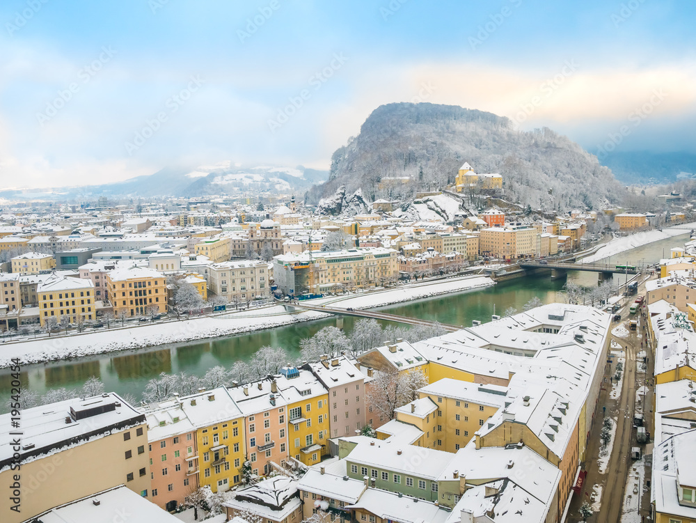 Beautiful panoramic view of Salzburg skyline with river Salzach in winter season snow , Austria