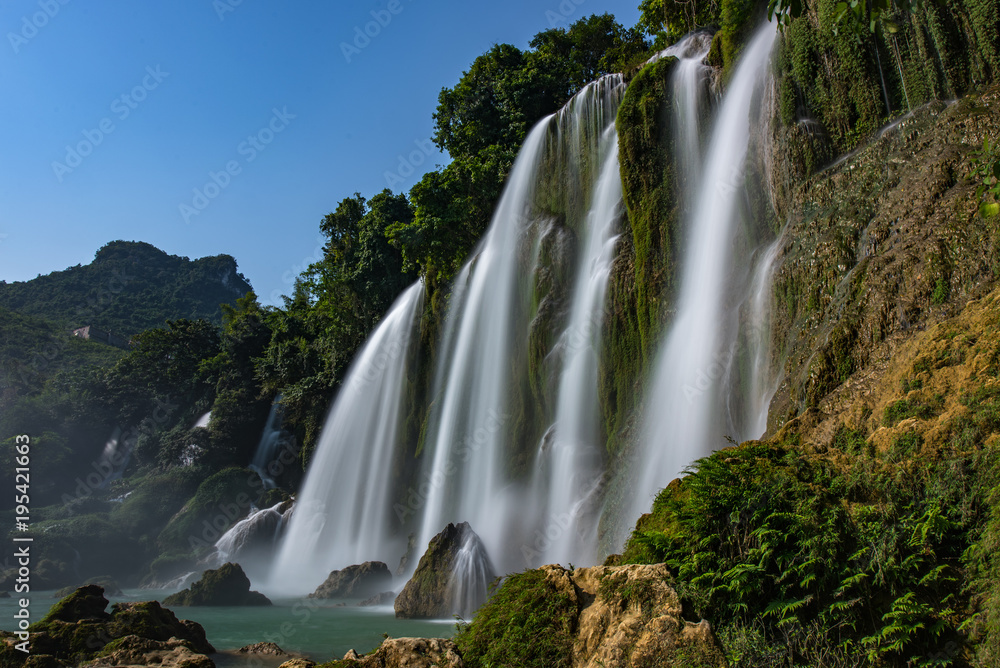 Naklejka premium Ban Gioc Waterfall - Detian waterfall Ban Gioc Waterfall - Detian waterfall Ban Gioc Waterfall is the most magnificent waterfall in Vietnam, located in Dam Thuy Commune, Trung Khanh District, Cao Bang