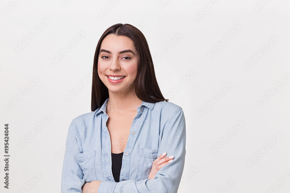 hispanic woman smiling with arms crossed hispanic woman smiling with arms crossed
