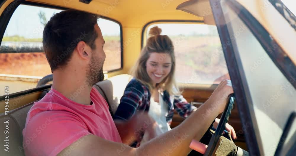 Couple interacting while sitting together in a car Couple interacting while sitting together in a car