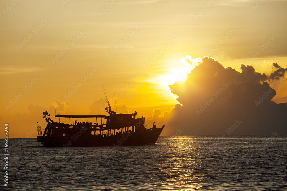 silhouete photography of beautiful sunset sky and tourist diving boat