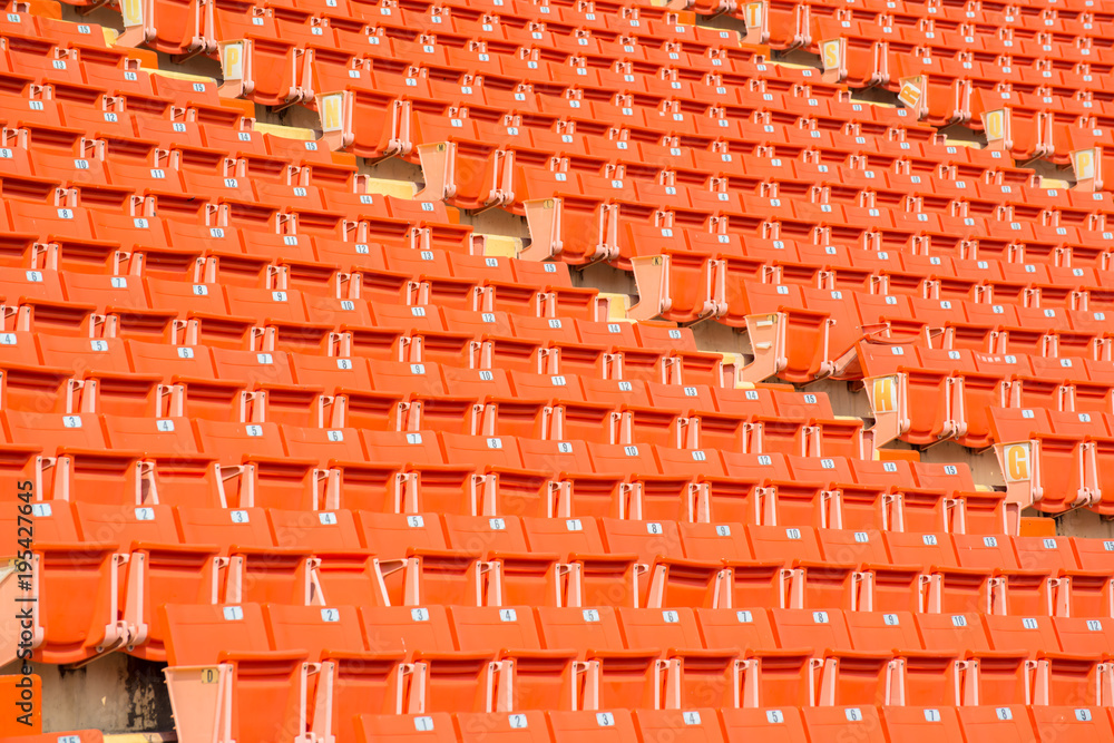 Orange chairs, many in the soccer stadium. Orange chairs, many in the soccer stadium.