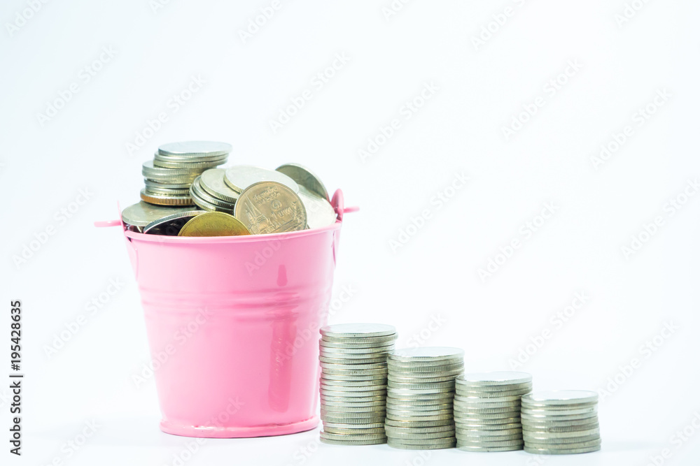 Full coins in pink bucket with row of coin money on white background ...