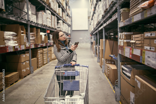 Wallpaper Mural girl looking for goods on the shelf Torontodigital.ca