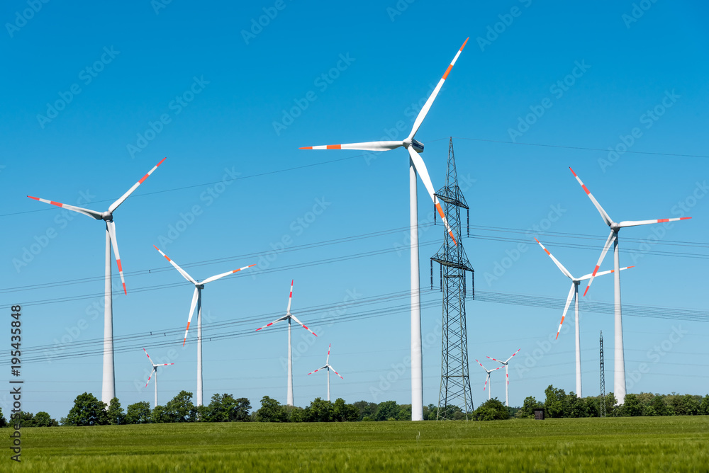 Power supply lines and wind turbines seen in rural Germany Power supply lines and wind turbines seen in rural Germany