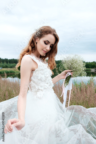 young pretty bride in white wedding dress outdoors, make up and hairstyle © Kiryl Lis