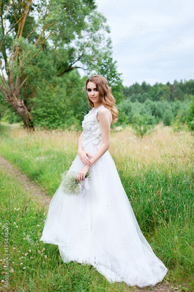 young pretty bride in white wedding dress outdoors, make up and hairstyle