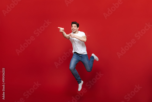 Full length portrait of a cheerful young man