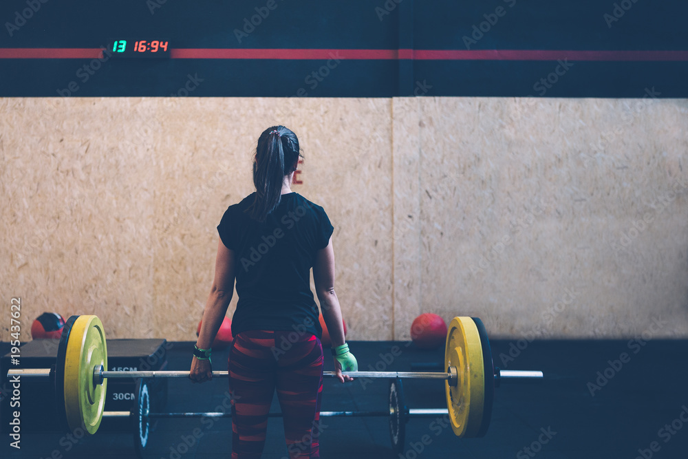 Girl athlete doing deadlift exercise Girl athlete doing deadlift exercise