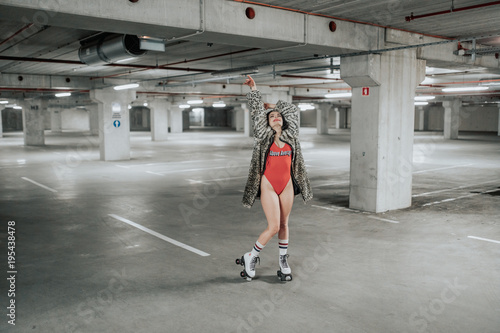 young sexy woman rollerskating in an urban looking garage and posing in a hipster like matter © SVP Productions