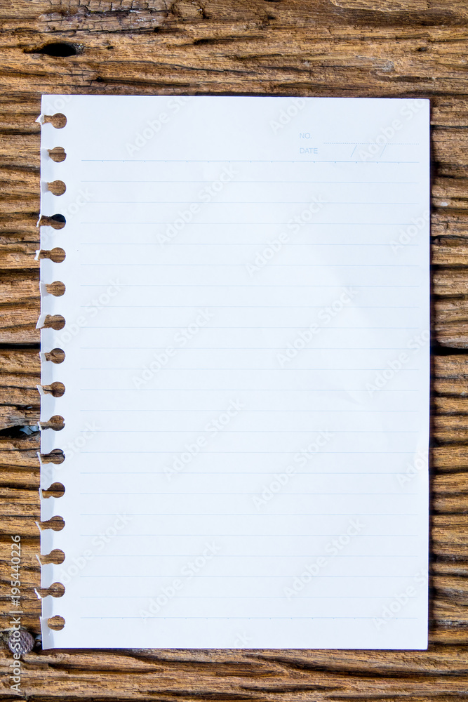 Top view of notebok with pencil, smart phone and calculator on wooden table. Emtry page for text.