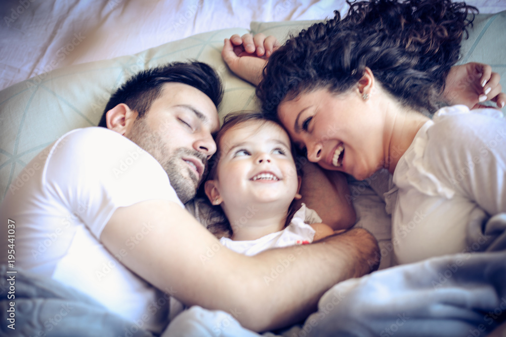 Portrait of happy family in bed at morning. Portrait of happy family in bed at morning.
