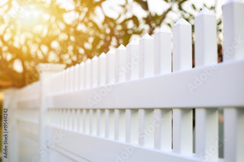 Fotobehang White picket or fence ready made for installed around the house.