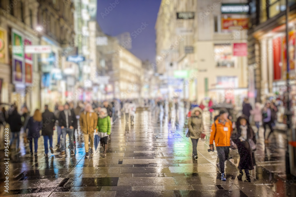 crow of people walking on rainy night streets 