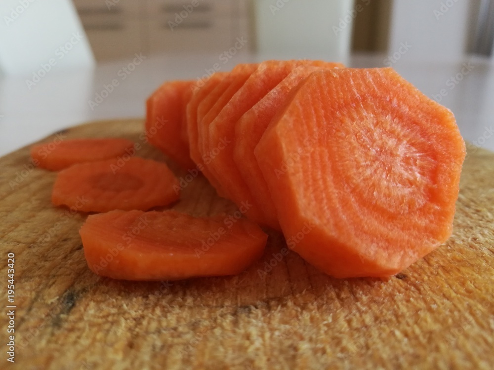Sliced carrot on a cutting board. Sliced carrot on a cutting board.