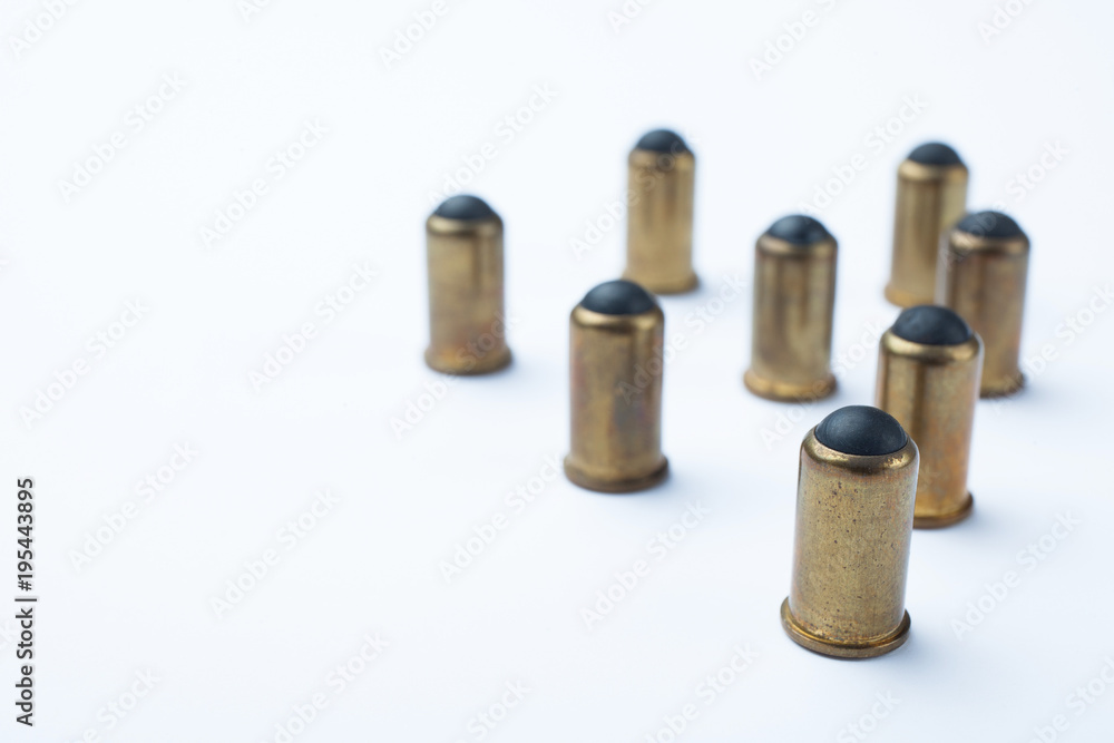 Old rubber bullets on a white background. Empty space for text. Old rubber bullets on a white background. Empty space for text.