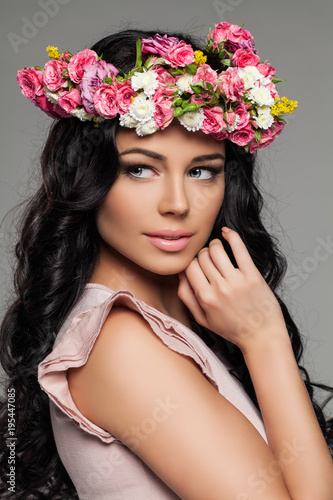 Cute Female Face with Flowers. Pretty Woman with Makeup and Floral Hairstyle