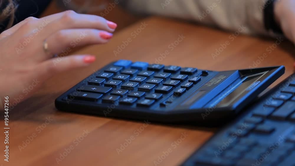 woman counts on a close-up calculator woman counts on a close-up calculator