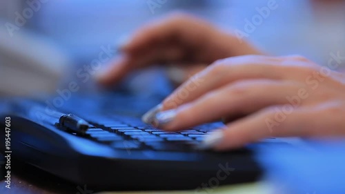 Woman typing text on keyboard close up