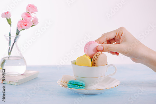 Sweet dessert. Colorful macarons on table in morning. photo