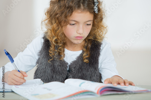 girl doing homeworks alone