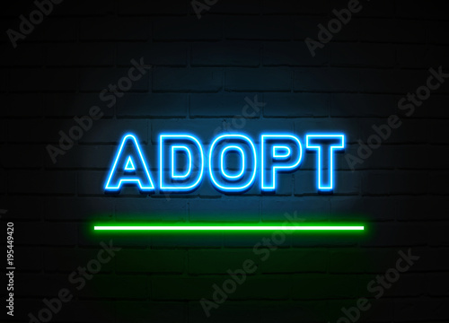 Adopt neon sign mounted on brick wall.