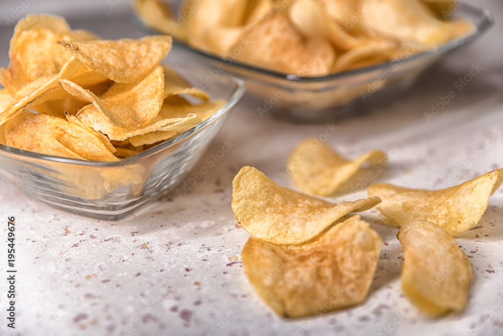 potato chips on a plate on a white background