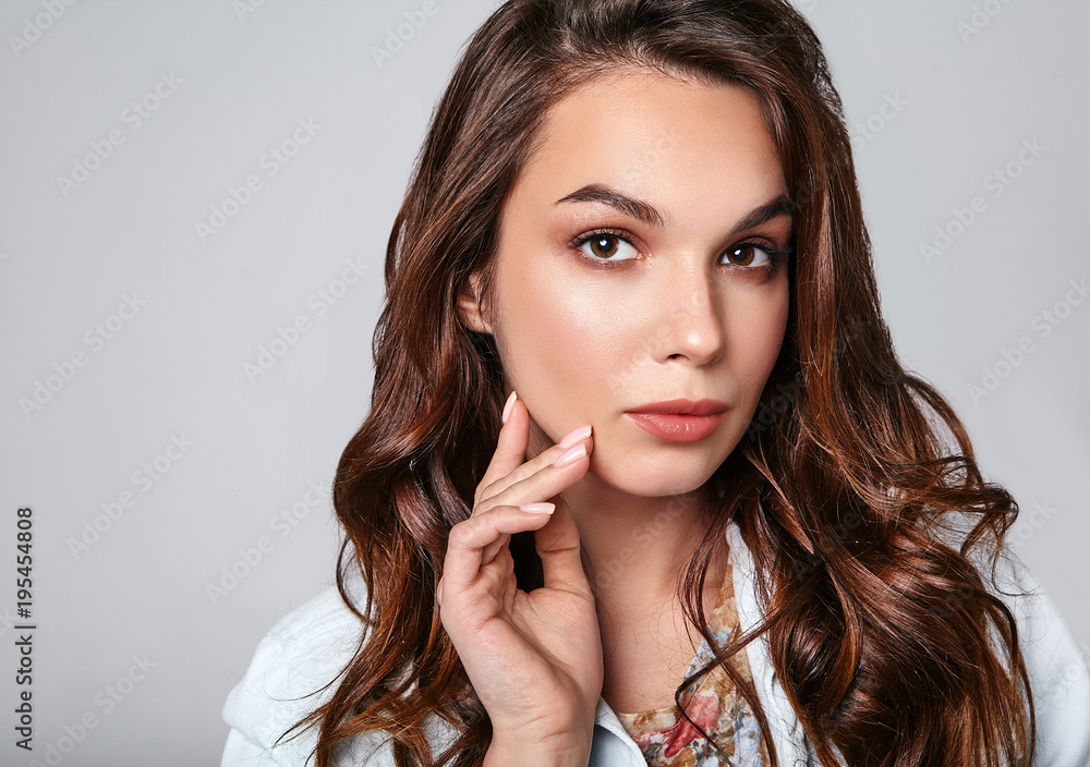 Portrait of young stylish laughing girl model in colorful casual summer clothes with natural makeup isolated on gray background. Looking at camera Portrait of young stylish laughing girl model in colorful casual summer clothes with natural makeup isolated on gray background. Looking at camera