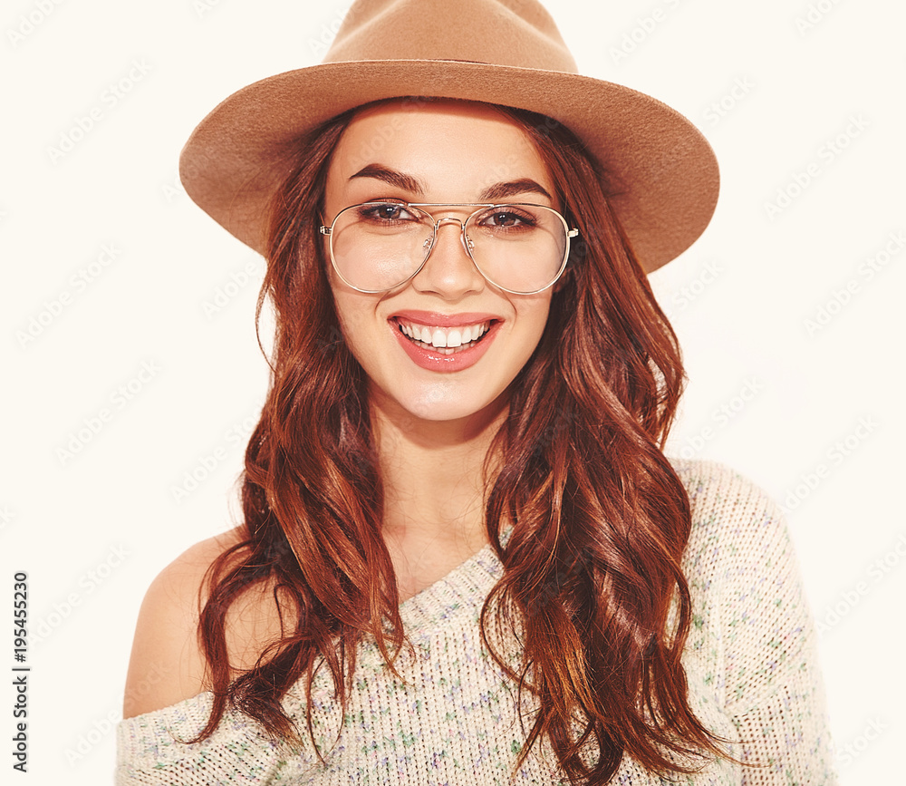 Portrait of young stylish girl model in casual summer clothes in brown hat with natural makeup in glasses isolated on white background. Looking at camera Portrait of young stylish girl model in casual summer clothes in brown hat with natural makeup in glasses isolated on white background. Looking at camera