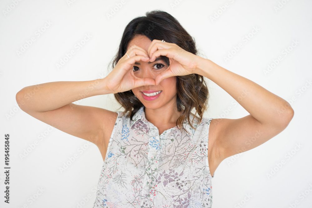 Happy pretty girl showing heart with hands Happy pretty girl showing heart with hands