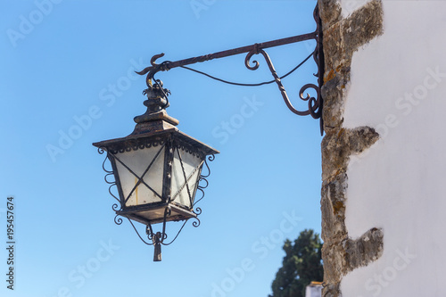 Ancient Portuguese street lights. On walls of houses. photo