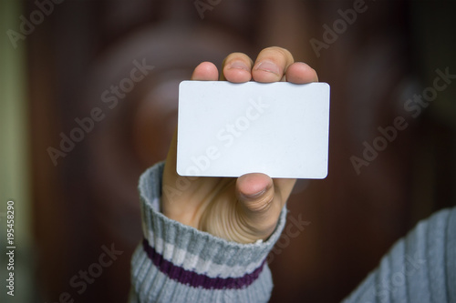 Man holding white business card