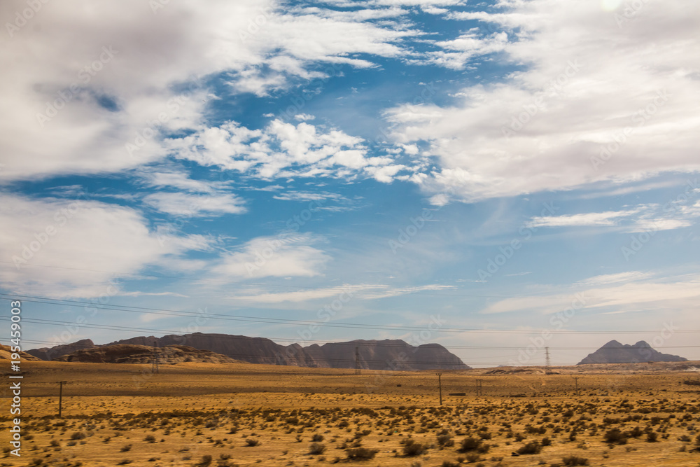 Naklejka premium Mountains and sky with clouds in Jordan in a day