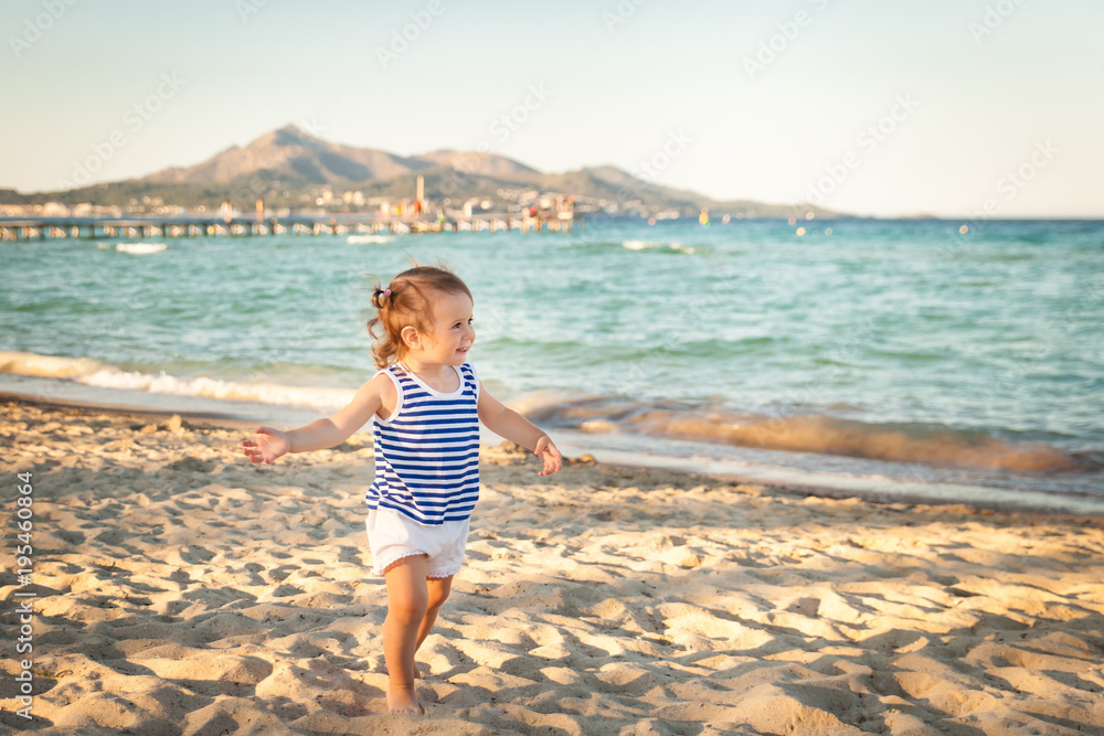 Cute girl on a beach on sunset. Mallorca, Spain