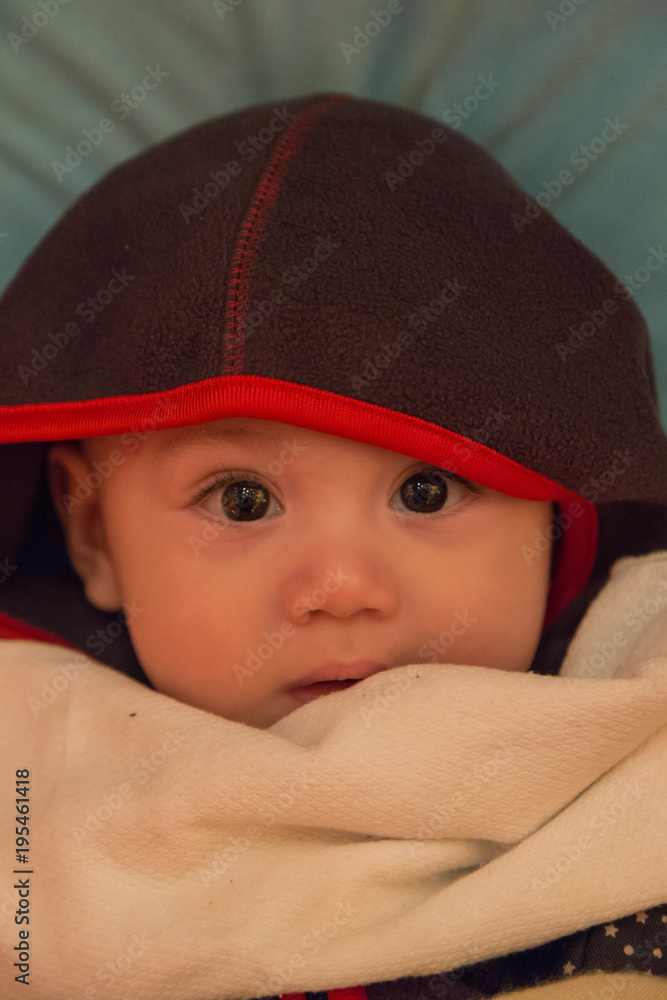 Baby boy looking intently with reflections of lanterns in his eyes. Baby boy looking intently with reflections of lanterns in his eyes.