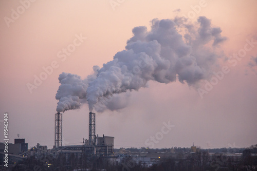 Chimney smoking stack. Air pollution and climate change theme. Poor environment in the city. Environmental disaster. Harmful emissions into the environment. Smoke and smog. 