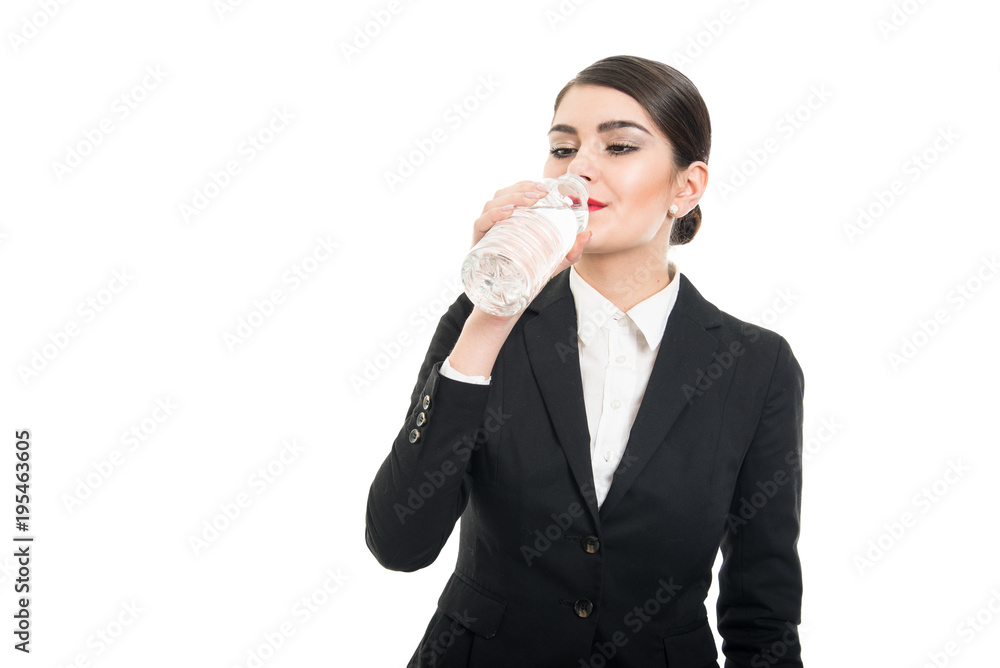Beautiful stewardess drinking from bottle of water Beautiful stewardess drinking from bottle of water