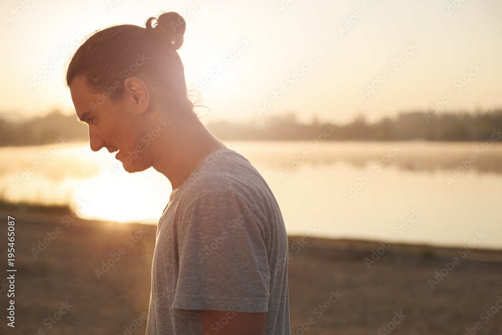 Fototapeta premium Handsome man resting after workout in the park