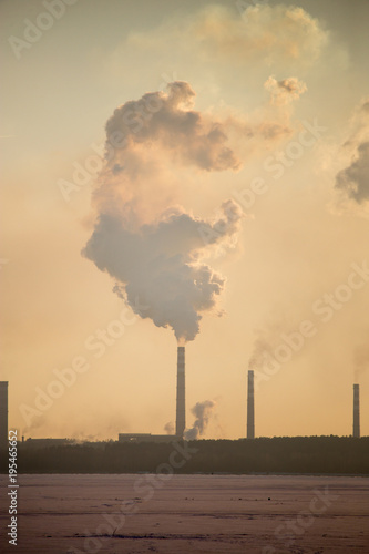 Smoke from the pipes of an industrial plant in the morning