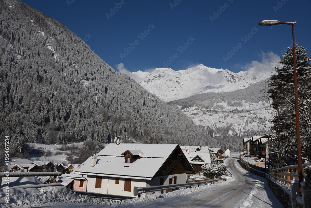paesaggio invernale castello boschi neve nevicata montagne cime innevate 