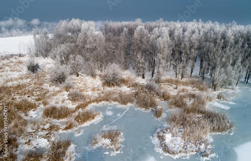 Winter landscape of frozen river in forest