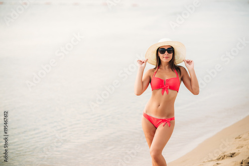 Sexy girl in a pink bathing suit on the beach. Summer . sunny weather